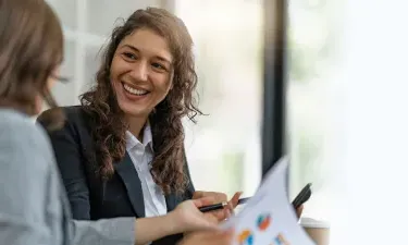 Project man年龄r with bachelor's degree smiling during meeting